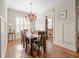 Spacious dining room with hardwood floors, elegant lighting, and shuttered windows at 4595 Carriage Walk Ln, Cumming, GA 30040