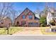 Charming stone home featuring a well-manicured lawn and two-car garage at 4595 Carriage Walk Ln, Cumming, GA 30040