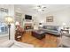 Cozy living room with hardwood floors, stone fireplace, and built-in shelving, creating an inviting atmosphere at 4595 Carriage Walk Ln, Cumming, GA 30040