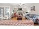 Cozy living room boasts built-in shelves surrounding a stone fireplace, with plush seating at 4595 Carriage Walk Ln, Cumming, GA 30040