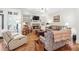 Bright living room features a fireplace, built-in shelving, and hardwood floors at 4595 Carriage Walk Ln, Cumming, GA 30040