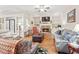 Inviting living room with fireplace, built-ins, and lots of natural light at 4595 Carriage Walk Ln, Cumming, GA 30040