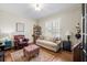 Cozy living room with hardwood floors, comfortable seating, and natural light at 4595 Carriage Walk Ln, Cumming, GA 30040