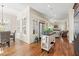 Open concept living space featuring dining and living rooms with wooden floors at 4595 Carriage Walk Ln, Cumming, GA 30040