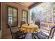 Cozy covered outdoor patio with seating, ideal for relaxation and enjoying the natural surroundings at 4595 Carriage Walk Ln, Cumming, GA 30040