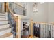 Elegant staircase with decorative iron railings and wood accents, enhancing the home's architectural details at 4595 Carriage Walk Ln, Cumming, GA 30040