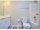 Clean bathroom with white vanity, toilet and bathtub at 6764 Blantyre Blvd, Stone Mountain, GA 30087