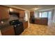 Kitchen with dark wood cabinets and tile flooring at 4225 Ward Bluff Dr, Ellenwood, GA 30294