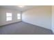 Spacious bedroom with neutral carpeting and large windows at 5450 Crow Dr, Cumming, GA 30041