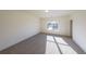 Bright bedroom with grey carpet and large window at 5450 Crow Dr, Cumming, GA 30041
