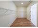 Large walk-in closet with wire shelving and hardwood floors at 5450 Crow Dr, Cumming, GA 30041