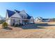Two story home with gray brick and a large yard, other homes visible in background at 5450 Crow Dr, Cumming, GA 30041