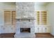 Stone fireplace with built-in shelves and cabinets on either side at 5450 Crow Dr, Cumming, GA 30041
