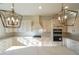 Bright kitchen with white cabinets, gas cooktop, and stylish light fixtures at 5450 Crow Dr, Cumming, GA 30041