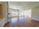 Open concept living room and kitchen with hardwood floors and a stone fireplace at 5450 Crow Dr, Cumming, GA 30041