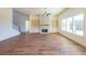Spacious living room with hardwood floors, built-in shelves, and a stone fireplace at 5450 Crow Dr, Cumming, GA 30041