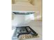 Modern gas cooktop with stainless steel accents at 5450 Crow Dr, Cumming, GA 30041