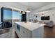 Modern kitchen with island, stainless steel appliances and living room view at 1820 Peachtree Nw St # 1005, Atlanta, GA 30309