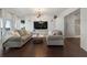 Bright living room with hardwood floors, large TV, and sofas at 1820 Peachtree Nw St # 1005, Atlanta, GA 30309
