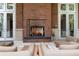 Brick fireplace on a patio with comfortable seating at 1820 Peachtree Nw St # 1005, Atlanta, GA 30309
