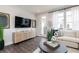 Living room with a large TV, stylish cabinet, and access to a deck at 2654 Brookview Nw Ln, Atlanta, GA 30318