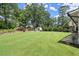 Large grassy backyard with shed and stone patio at 4360 Webb Bridge Rd, Alpharetta, GA 30005