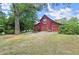 Red barn with garage doors and a charming setting at 4360 Webb Bridge Rd, Alpharetta, GA 30005