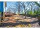 Backyard view with a wood fence, trees, lawn and the back of the house including the deck at 110 Bowen Sw Cir, Atlanta, GA 30315