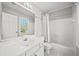 Bright bathroom featuring a mirror, sink, toilet and shower-tub combo at 110 Bowen Sw Cir, Atlanta, GA 30315