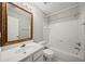Bathroom featuring a vanity, toilet, and combined tub and shower with white tile surround at 110 Bowen Sw Cir, Atlanta, GA 30315