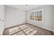 Bedroom with neutral carpet, walls, ceiling fan, and natural light coming through a window at 110 Bowen Sw Cir, Atlanta, GA 30315