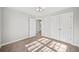 Bedroom with neutral walls, carpet, closet and a view through the door to a bathroom at 110 Bowen Sw Cir, Atlanta, GA 30315