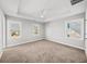 Well lit carpeted bedroom with a tray ceiling and three windows at 110 Bowen Sw Cir, Atlanta, GA 30315