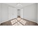 Bright bedroom featuring neutral walls, carpet, ceiling fan, double closet, and natural light at 110 Bowen Sw Cir, Atlanta, GA 30315