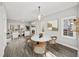 Open-concept dining room with a marble table, fireplace, and seamless access to the living room at 110 Bowen Sw Cir, Atlanta, GA 30315