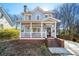 Inviting two-story home featuring a cozy front porch with swing and brick steps at 110 Bowen Sw Cir, Atlanta, GA 30315