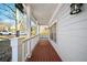 Inviting front porch with wood flooring and classic white railings and posts at 110 Bowen Sw Cir, Atlanta, GA 30315