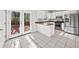 Well-lit kitchen featuring white cabinetry and stainless steel appliances, complemented by deck access at 110 Bowen Sw Cir, Atlanta, GA 30315