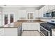 Kitchen with granite countertops, stainless steel appliances, and white cabinetry at 110 Bowen Sw Cir, Atlanta, GA 30315