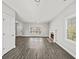 View of the living room with a fireplace, large windows, and a ceiling fan at 110 Bowen Sw Cir, Atlanta, GA 30315