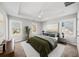 Bedroom with tray ceiling, fan, multiple windows, neutral paint and carpet at 110 Bowen Sw Cir, Atlanta, GA 30315