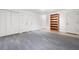 Spacious basement with gray carpeting and built-in shelving at 1229 Whitlock Ridge Sw Dr, Marietta, GA 30064