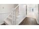 White staircase with carpeted steps and hardwood flooring at 1229 Whitlock Ridge Sw Dr, Marietta, GA 30064