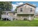 Tan house exterior with deck and stairs, spacious backyard at 3980 Carlton Cove Ct, Loganville, GA 30052