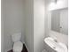 Small half bathroom with pedestal sink and toilet at 4154 Magnolia Glen Walk, Norcross, GA 30093