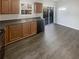 Kitchen with wood cabinets, dark laminate flooring and sliding glass door at 4154 Magnolia Glen Walk, Norcross, GA 30093