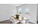 Bright dining area with gold table and white chairs near sliding door at 509 Elkwood Ln, Mcdonough, GA 30252