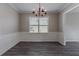 Elegant dining room, hardwood floors, chandelier, and wainscoting at 7336 Toccoa Cir, Union City, GA 30291