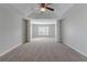 Spacious main bedroom with high ceilings, carpet, and ceiling fan at 7336 Toccoa Cir, Union City, GA 30291