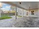 Covered patio with slate tile flooring, overlooks a grassy backyard with a swimming pool at 1043 Belmont Commons Dr, Smyrna, GA 30080